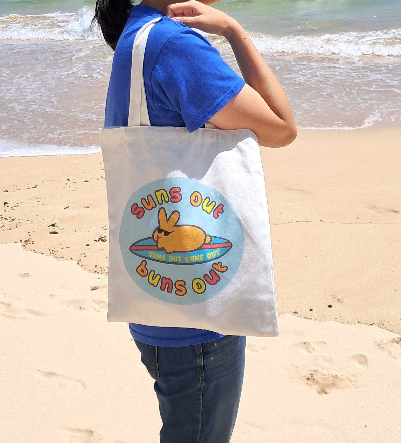 suns out buns out tote bag at the beach